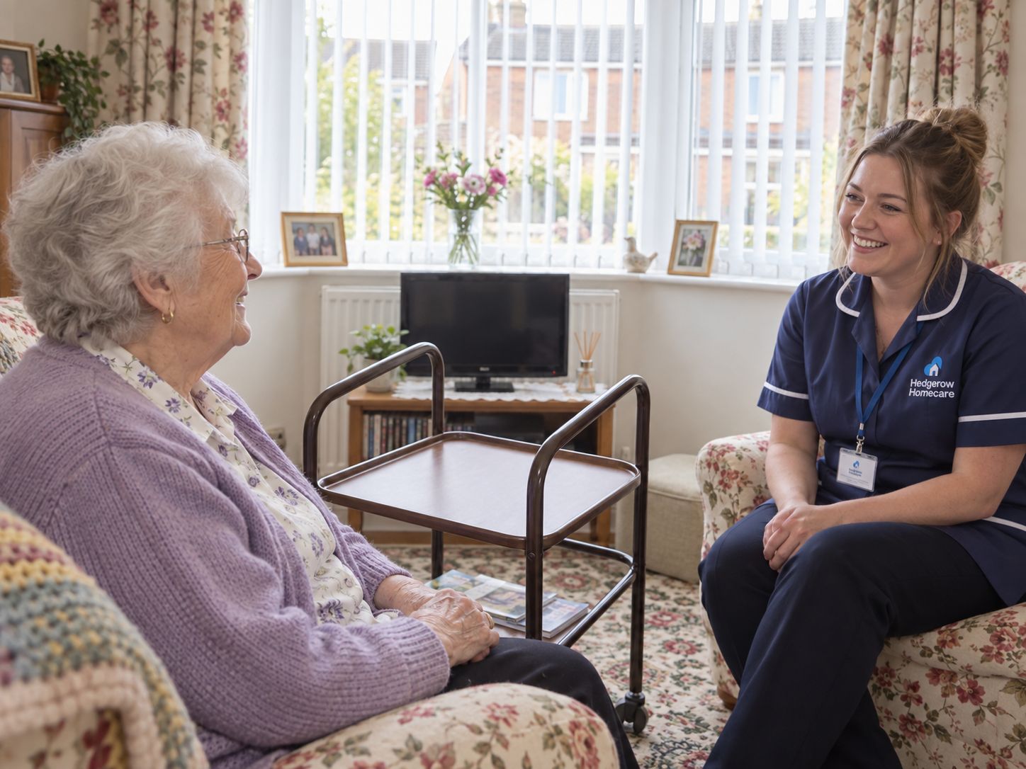 A Hedgerow carer chatting with an older woman in her living room